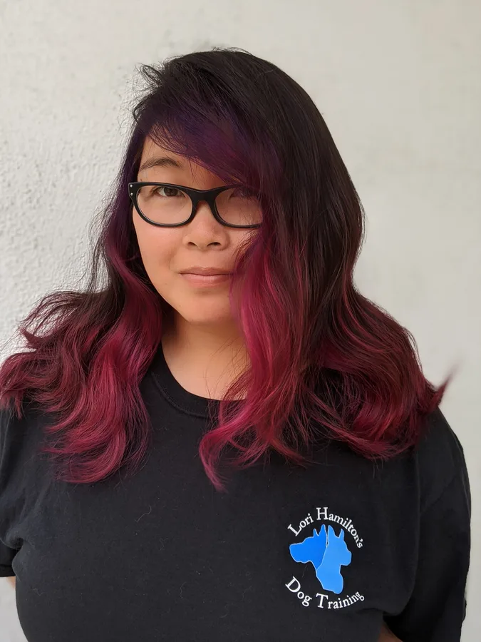 Long layered hair in a deep burgundy red after color correction