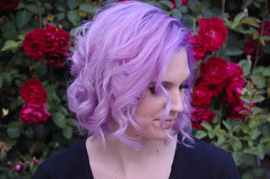 Curly lilac bob shaped to the natural curl pattern